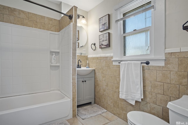 529 11th St, Sparks, NV 89431 - bathroom featuring tile walls, toilet, vanity, shower / bathtub combination, and tile patterned flooring