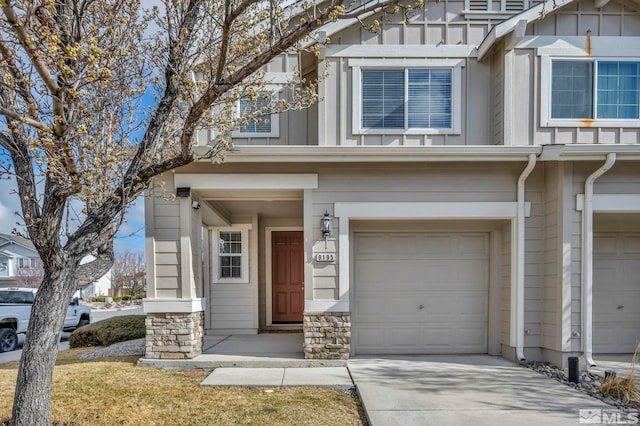 9195 Brown Eagle Ct, Reno, NV 89506 - view of front of house featuring an attached garage, board and batten siding, stone siding, and concrete driveway