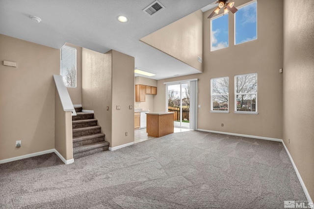 9195 Brown Eagle Ct, Reno, NV 89506 - unfurnished living room featuring ceiling fan, light carpet, baseboards, stairway, and recessed lighting