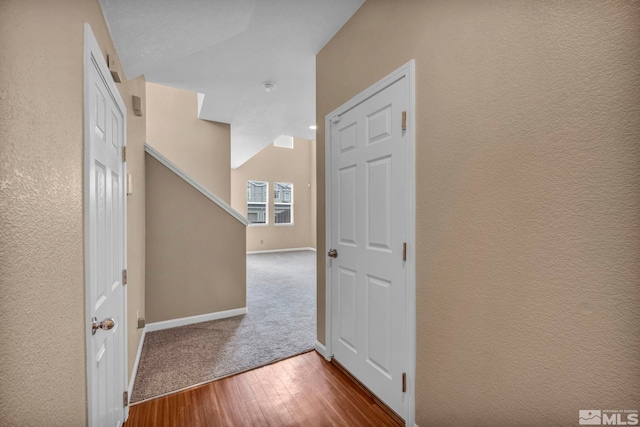 9195 Brown Eagle Ct, Reno, NV 89506 - corridor featuring wood finished floors, baseboards, and stairs