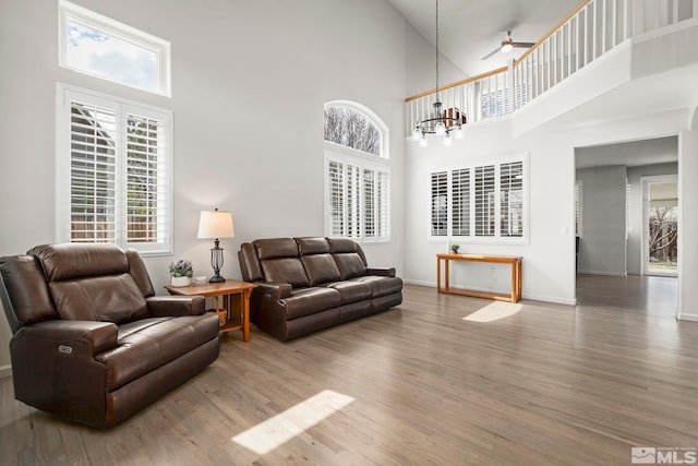 5895 Tappan Dr, Reno, NV 89523 - living area featuring a high ceiling, wood finished floors, ceiling fan, and baseboards