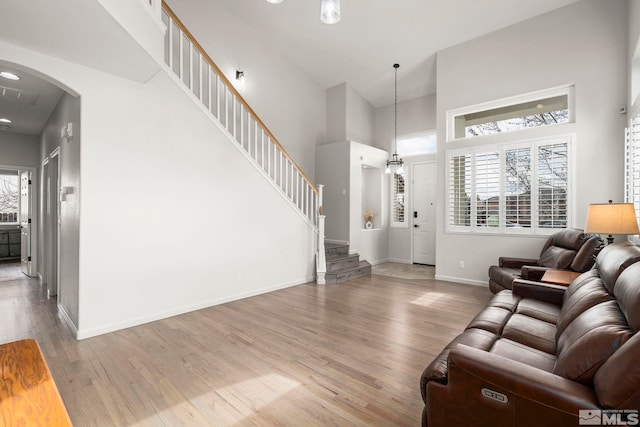 5895 Tappan Dr, Reno, NV 89523 - living room with wood finished floors, a towering ceiling, plenty of natural light, and baseboards
