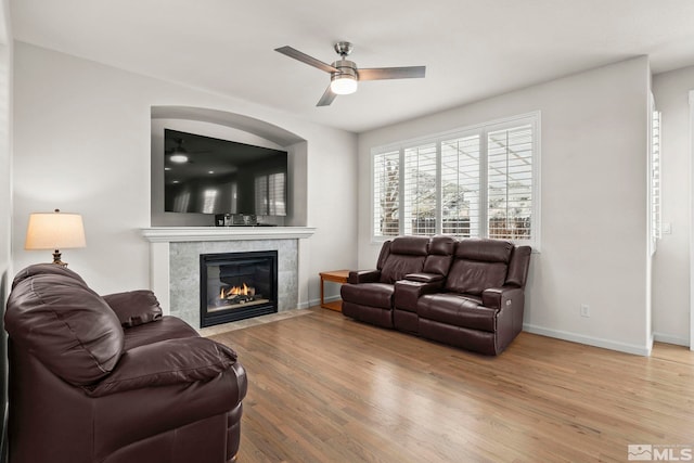 5895 Tappan Dr, Reno, NV 89523 - living room with a ceiling fan, wood finished floors, a tile fireplace, and baseboards