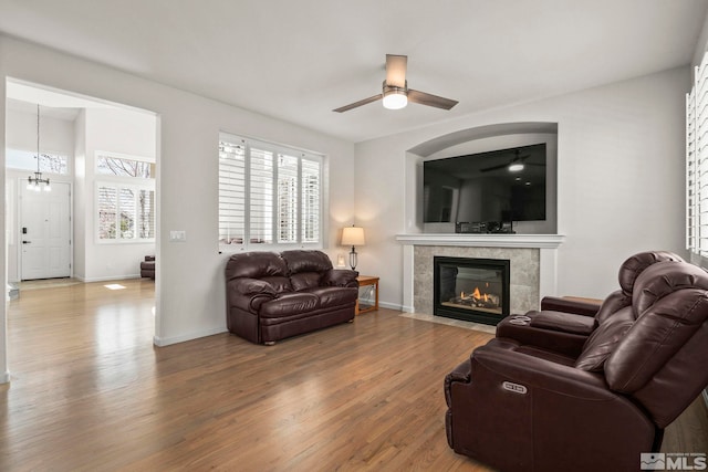 5895 Tappan Dr, Reno, NV 89523 - living area featuring a ceiling fan, wood finished floors, a tile fireplace, a chandelier, and baseboards