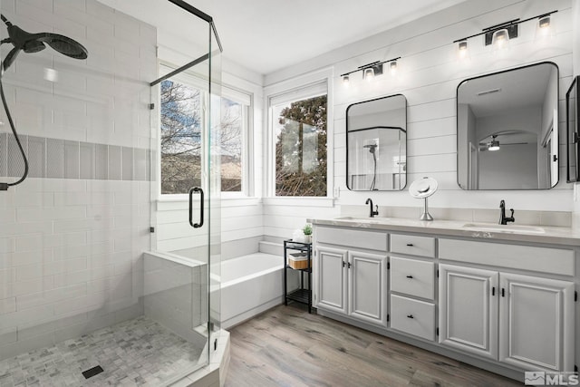 5895 Tappan Dr, Reno, NV 89523 - full bathroom with a shower stall, a garden tub, wood finished floors, double vanity, and ceiling fan