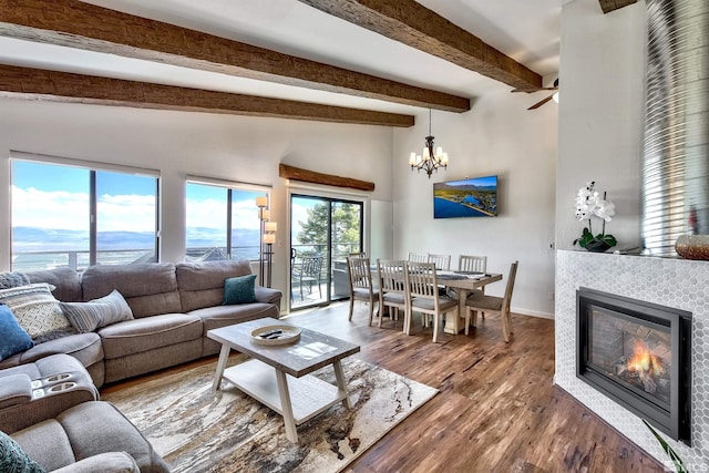 243 Tramway Dr, Stateline, NV 89449 - living area with a fireplace, wood finished floors, a chandelier, baseboards, and beam ceiling