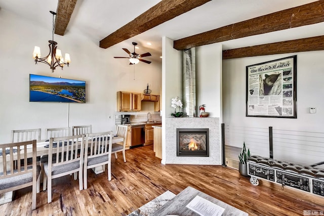 243 Tramway Dr, Stateline, NV 89449 - living room featuring wood finished floors, ceiling fan, a chandelier, a fireplace, and beamed ceiling