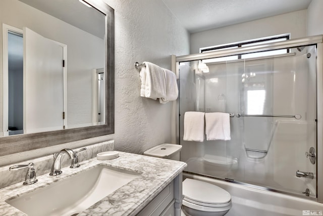 243 Tramway Dr, Stateline, NV 89449 - full bathroom with a textured wall, vanity, enclosed tub / shower combo, and toilet
