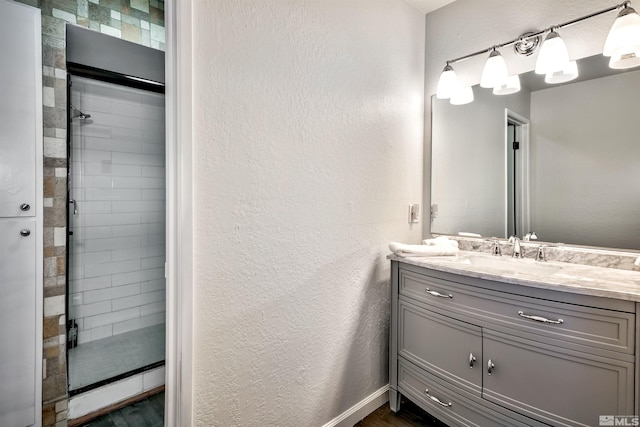 243 Tramway Dr, Stateline, NV 89449 - full bath featuring a stall shower, vanity, wood finished floors, a textured wall, and baseboards