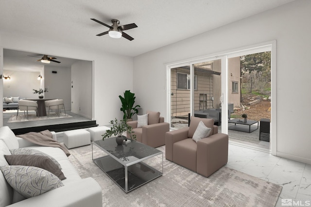 living room featuring ceiling fan, marble look tiles, and baseboards