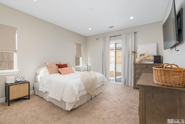 bedroom with light colored carpet, access to exterior, and recessed lighting