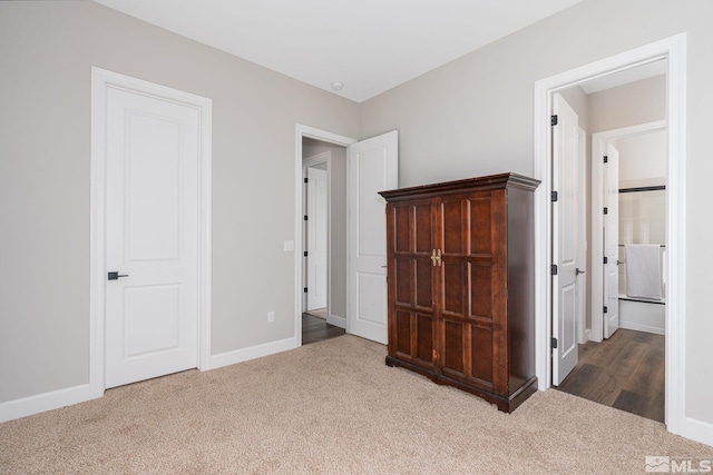 unfurnished bedroom with carpet and baseboards