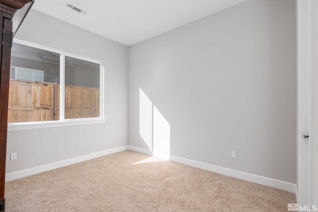 spare room with carpet floors and baseboards