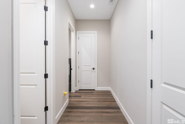 hallway with dark wood-style floors, baseboards, and recessed lighting