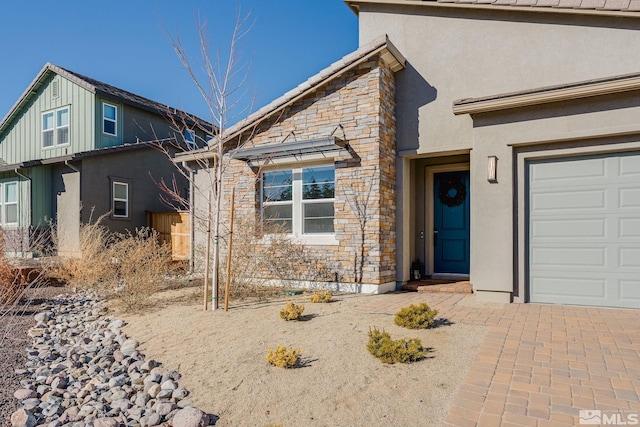 view of front facade featuring stone siding and stucco siding