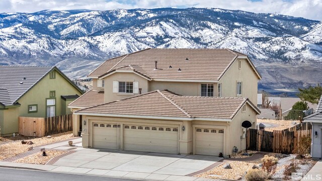 2861 Sunline Dr, Reno, NV 89523 - traditional-style house with a mountain view, a garage, stucco siding, and concrete driveway