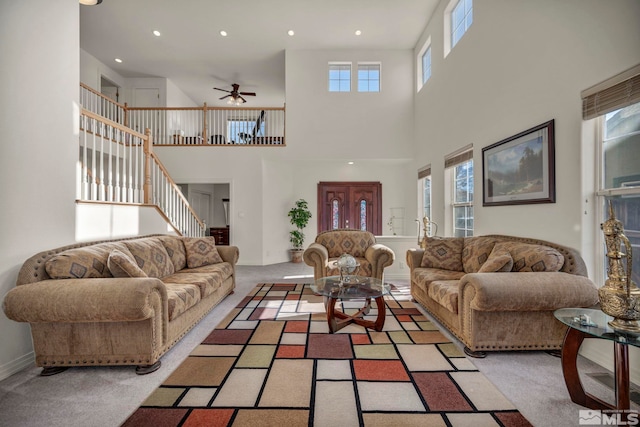 2861 Sunline Dr, Reno, NV 89523 - living area with a ceiling fan, plenty of natural light, carpet flooring, a high ceiling, and stairs