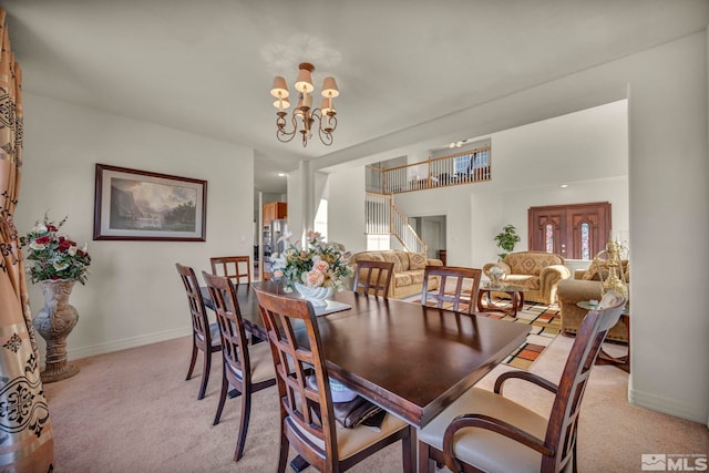 2861 Sunline Dr, Reno, NV 89523 - dining room featuring light carpet, stairway, baseboards, and a chandelier