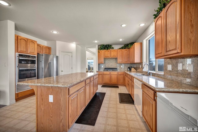 2861 Sunline Dr, Reno, NV 89523 - kitchen with appliances with stainless steel finishes, light floors, a sink, a center island, and recessed lighting