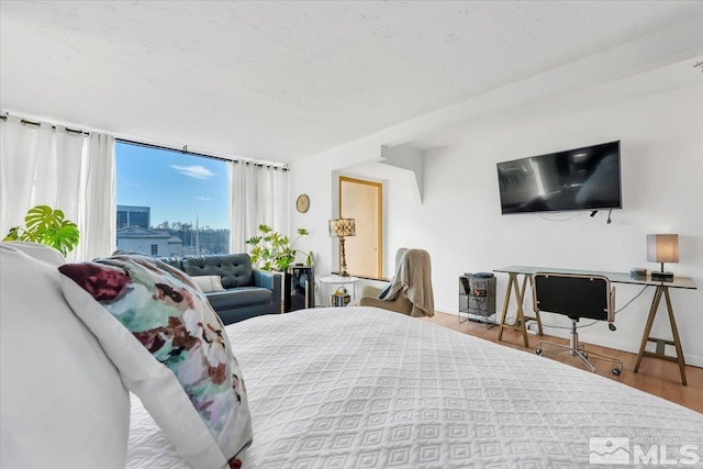 280 Island Ave Unit 607, Reno, NV 89501 - bedroom with wood finished floors, a textured ceiling, and baseboards