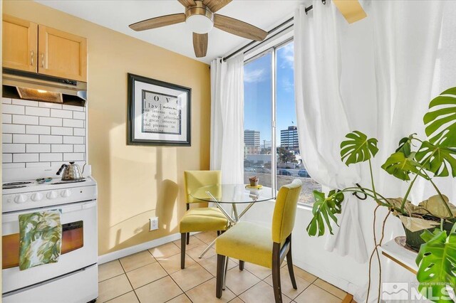 280 Island Ave Unit 607, Reno, NV 89501 - dining room with ceiling fan, light tile patterned flooring, a city view, and baseboards