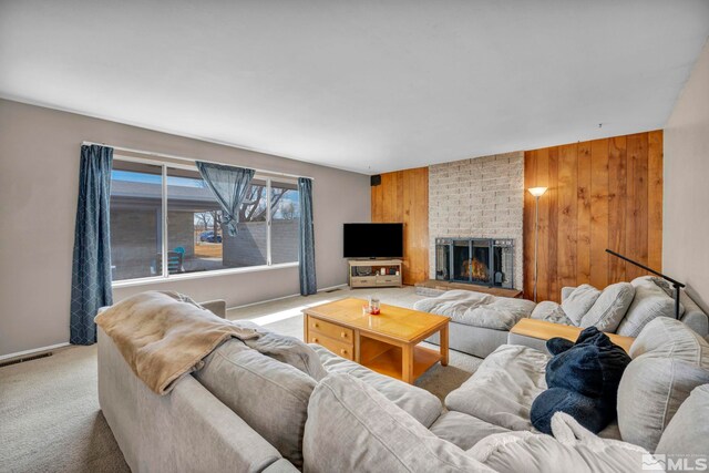 435 Cindy, Fallon, NV 89406 - living room featuring carpet, wood walls, a brick fireplace, and baseboards