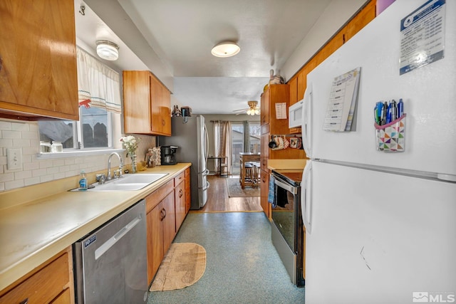 435 Cindy, Fallon, NV 89406 - kitchen with stainless steel appliances, brown cabinets, a sink, decorative backsplash, and light countertops