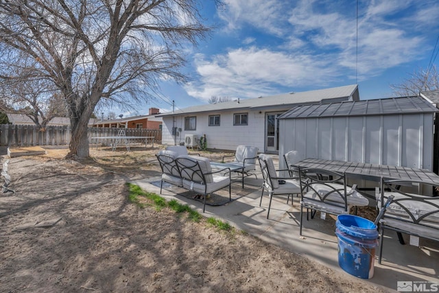 435 Cindy, Fallon, NV 89406 - back of property featuring fence, board and batten siding, a patio, outdoor dining space, and an outdoor structure