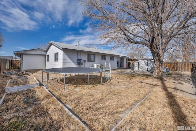 435 Cindy, Fallon, NV 89406 - rear view of property with a trampoline, a storage shed, a fenced backyard, an outdoor structure, and a vegetable garden