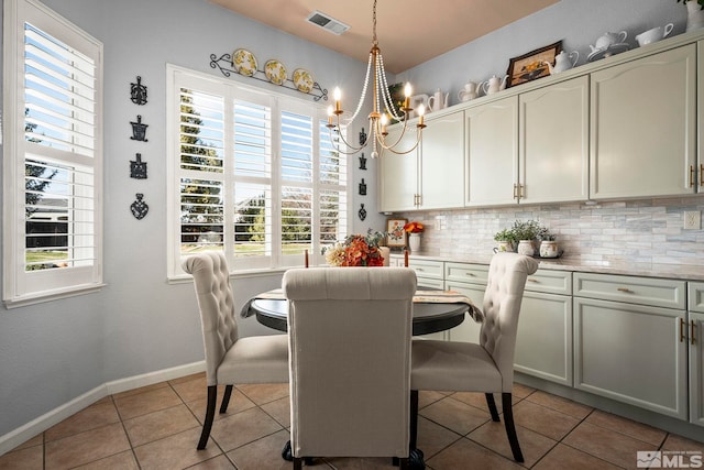 7972 Tres Arroyos Dr, Sparks, NV 89436 - dining area with light tile patterned floors, a chandelier, and baseboards