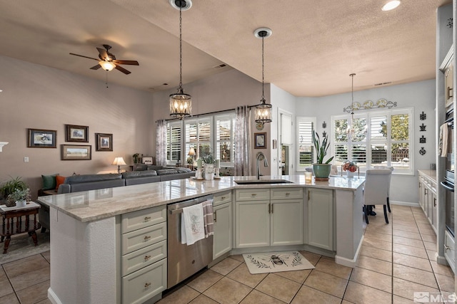 7972 Tres Arroyos Dr, Sparks, NV 89436 - kitchen featuring dishwasher, a sink, open floor plan, light tile patterned floors, and a textured ceiling