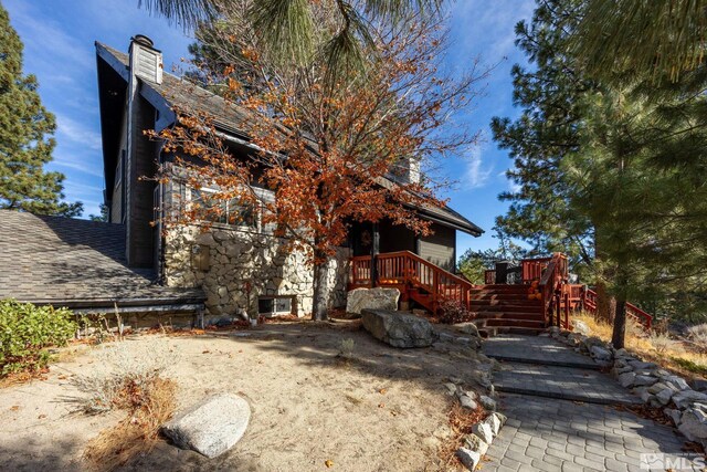 3055 US Highway 395, Washoe Valley, NV 89704 - view of side of home featuring a chimney and a deck