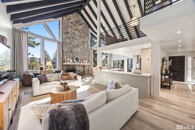 3055 US Highway 395, Washoe Valley, NV 89704 - living area featuring high vaulted ceiling, beamed ceiling, a fireplace, light wood finished floors, and recessed lighting