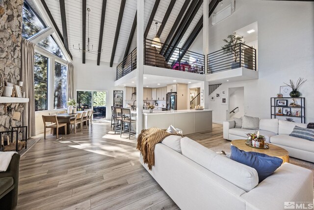 3055 US Highway 395, Washoe Valley, NV 89704 - living room with a high ceiling, light wood-style flooring, stairway, and beamed ceiling