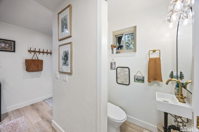 3055 US Highway 395, Washoe Valley, NV 89704 - bathroom featuring wood finished floors, toilet, and baseboards
