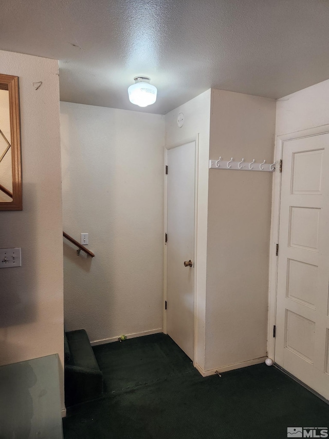 1363 Waterloo Ln, Gardnerville, NV 89410 - corridor with dark carpet, baseboards, and a textured ceiling