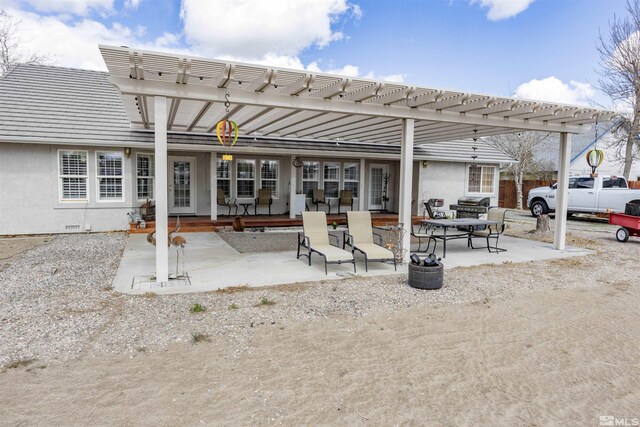 4635 Country River Dr, Fallon, NV 89406 - back of property featuring stucco siding, a pergola, and a patio area