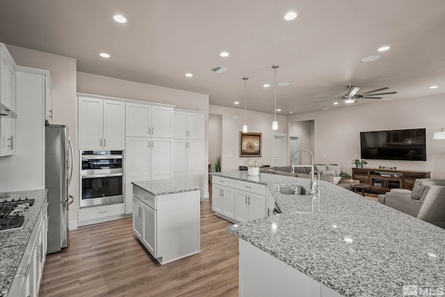 1046 Savona Ct, Dayton, NV 89403 - kitchen featuring a spacious island, stainless steel appliances, a sink, open floor plan, and ceiling fan