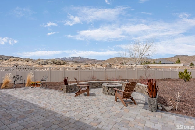 1046 Savona Ct, Dayton, NV 89403 - view of patio / terrace featuring a fire pit, a mountain view, and a fenced backyard