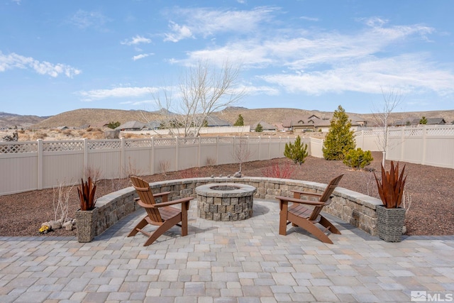 1046 Savona Ct, Dayton, NV 89403 - view of patio / terrace with a fire pit, a fenced backyard, and a mountain view