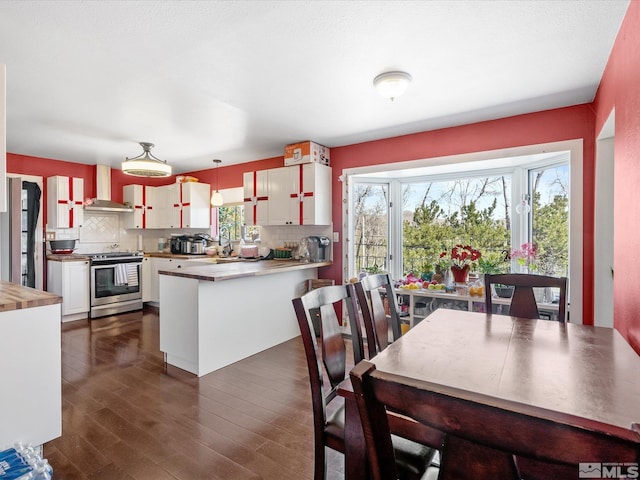 1879 Kings Canyon Rd, Carson City, NV 89703 - kitchen featuring electric range, wall chimney exhaust hood, healthy amount of natural light, and backsplash