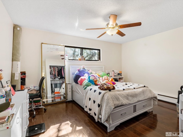1879 Kings Canyon Rd, Carson City, NV 89703 - bedroom featuring baseboard heating, wood-type flooring, ceiling fan, and a textured ceiling