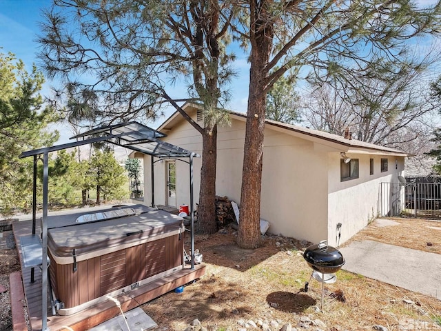 1879 Kings Canyon Rd, Carson City, NV 89703 - view of property exterior featuring a hot tub, stucco siding, and fence