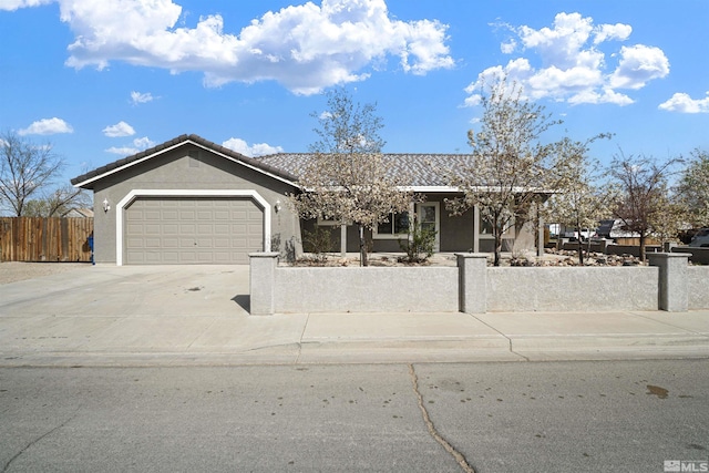 604 Venturacci Ln, Fallon, NV 89406 - ranch-style house with a fenced front yard, driveway, a garage, and stucco siding