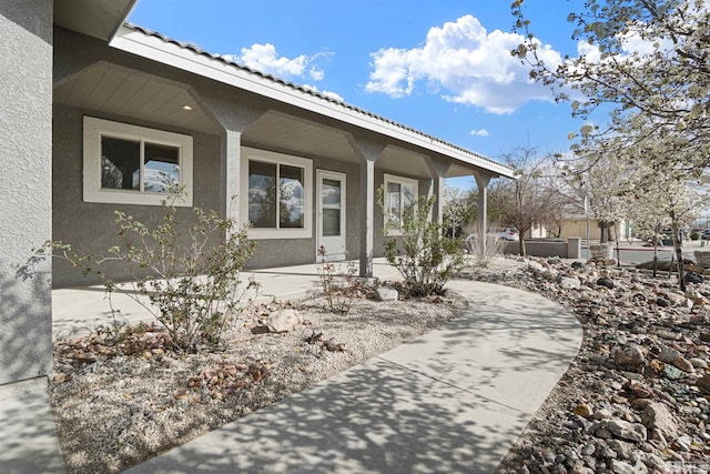 604 Venturacci Ln, Fallon, NV 89406 - doorway to property with stucco siding, covered porch, and a tile roof