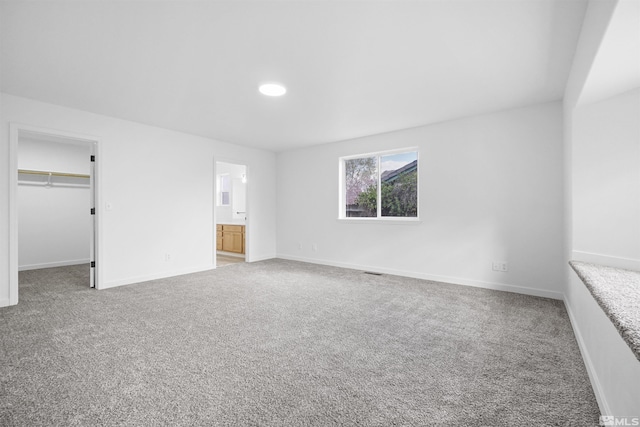 604 Venturacci Ln, Fallon, NV 89406 - unfurnished bedroom featuring carpet floors, a walk in closet, baseboards, ensuite bathroom, and recessed lighting