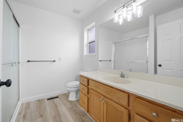 604 Venturacci Ln, Fallon, NV 89406 - full bath with wood finished floors, an enclosed shower, toilet, vanity, and baseboards