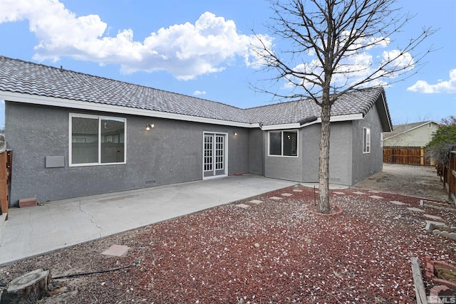 604 Venturacci Ln, Fallon, NV 89406 - back of house with a fenced backyard, stucco siding, a tiled roof, and a patio