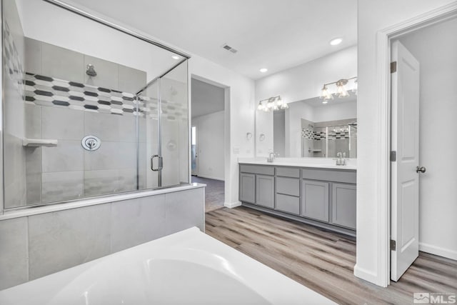 6772 Shell Ct Lot 49, Fernley, NV 89408 - bathroom featuring a shower stall, wood finished floors, double vanity, recessed lighting, and baseboards