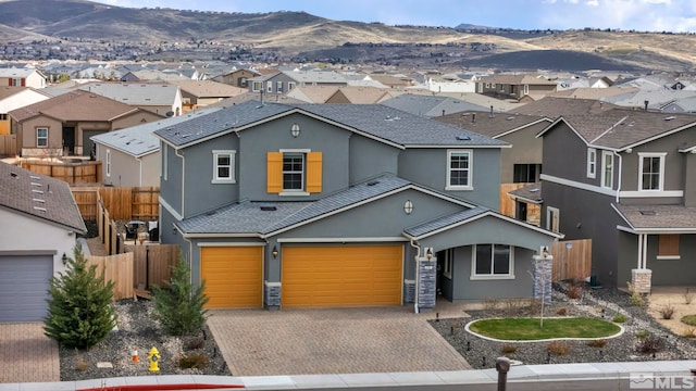 2181 Wyaconda Dr, Sparks, NV 89436 - traditional home with stucco siding, a residential view, a garage, decorative driveway, and fence